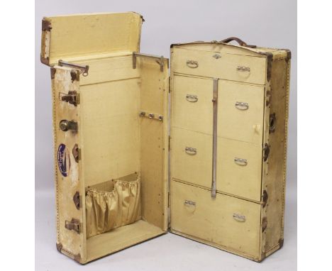A VELLUM COVERED WARDROBE TRUNK, EARLY 20TH CENTURY, the interior fitted with rails and drawers. 3ft 4ins high x 1ft 10ins wi