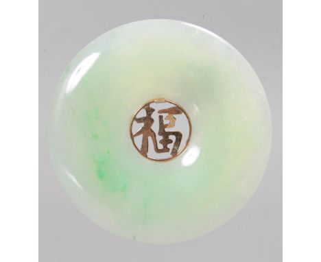 A CHINESE CARVED WHITE JADE PENDANT inset with gold Chinese calligraphy. 3.5cms diameter.