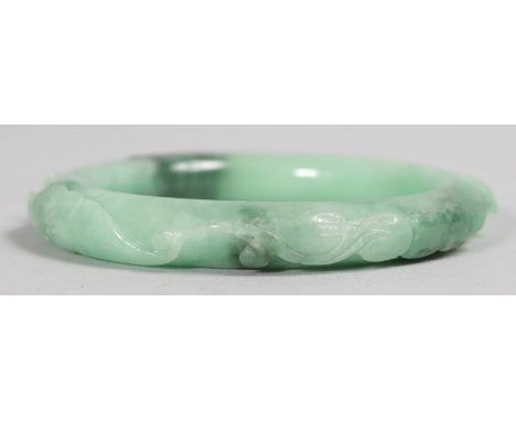 A GOOD CARVED JADE BANGLE.