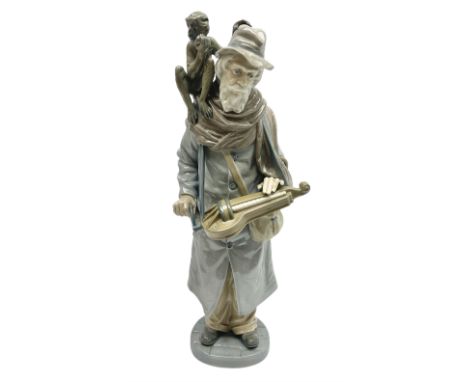 Lladro figure, Organ Grinder, modelled as an elderly man playing his hurdy gurdy instrument with a monkey seated upon his sho