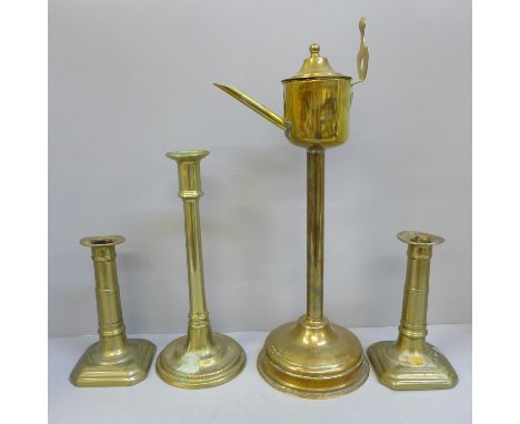 A Georgian brass whale oil lamp, a pair of gun barrel candlesticks and a tall single candlestick 