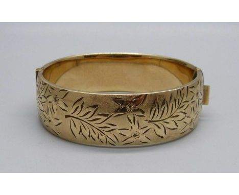 A heavy rolled gold engraved patented bangle, marked 1/5 9ct RG - maker R &amp; W 