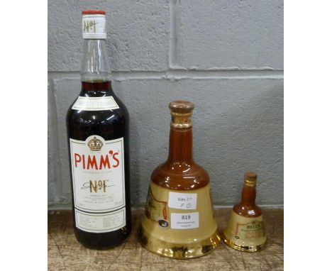 Two Bell's Scotch Whisky decanters and a bottle of Pimms 