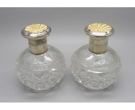 A pair of silver and enamel cut glass scent bottles, Birmingham 1934, enamel a/f on one 