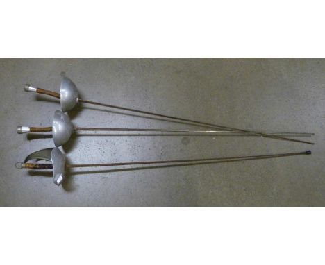 Three fencing swords, the hand guards marked Wilkinson Sword 