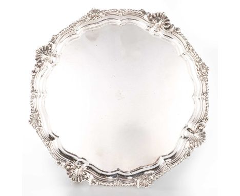 A LATE VICTORIAN SILVER SALVER by Harrison Brothers &amp; Howson, London 1899, with a moulded shell-capped gadroon border, en