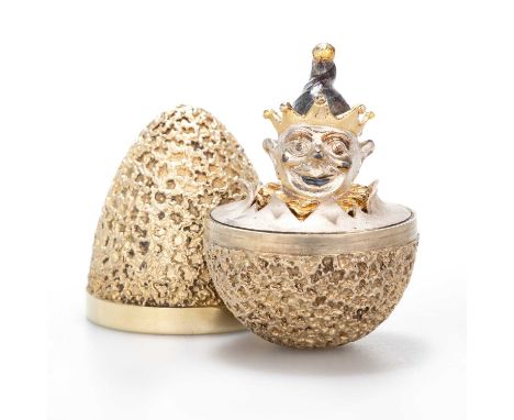 STUART DEVLIN: AN ELIZABETH II SILVER-GILT SURPRISE EGG by Stuart Devlin, London 1972, the textured egg opening to reveal a c