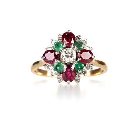 A DIAMOND, RUBY AND EMERALD CLUSTER RING a round brilliant-cut diamond within a border of oval-cut rubies, round-cut emeralds