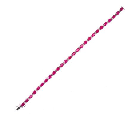 A RUBY AND DIAMOND BRACELET oval-cut ruby spaced by pairs of round brilliant-cut diamonds. Stated total diamond weight 0.46ct