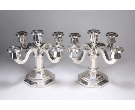 A PAIR OF CONTINENTAL SILVER CANDELABRA, 20TH CENTURY of substantial octagonal section, each with a centre light surrounded b