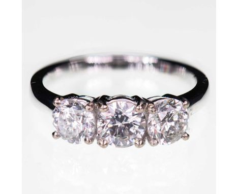 AN 18 CARAT WHITE GOLD DIAMOND THREE STONE RING three round brilliant-cut diamonds in claw settings, to a plain band. Estimat