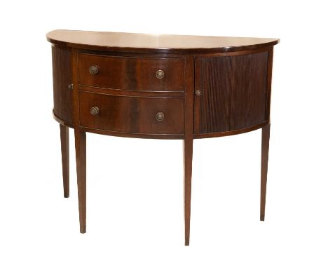 A GEORGE III STYLE MAHOGANY COMMODE, LATE 19TH CENTURY demilune, with a pair of tambour doors flanking a pair of drawers, rai
