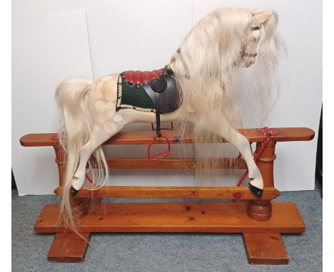 A 20th CENTURY DAPPLE GREY PAINTED ROCKING HORSE WITH LEATHERETTE TACK ON A TREADLE BASE LENGTH 45" HEIGHT 37"
ITEM NOT ON PR