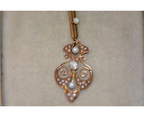 A diamond and seed pearl set 14ct gold pendant in the Edwardian taste, of shaped leaf design, centred by an old mine-cut diam