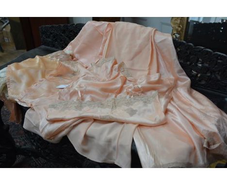 A group of 1930's/40's lingerie, part of a trousseau, comprising a variety of garments in peach satin or rayon, some applied 