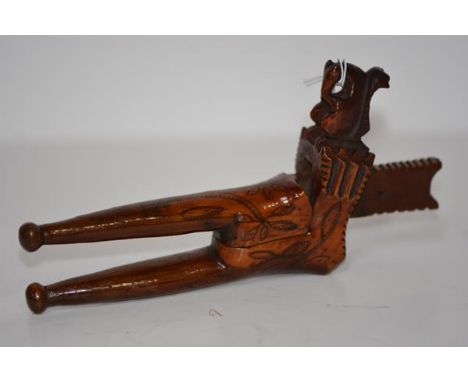 A rare treen nutcracker, probably English, c. 1700, lever action, decorated with trees in leaf and carved with a squirrel. Le
