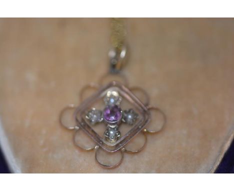 An Edwardian amethyst and seed pearl set pendant, centred by a round-cut amethyst in a lozenge plaque  set with seed pearls, 