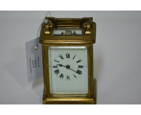 A French brass-cased carriage clock, early 20th century, stamped to the reverse "Made in France", the white enamel dial with 