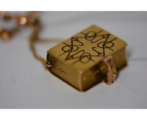A mid-19th century gold (unmarked) box in the form of a miniature missal or prayer book, the "spine" enamelled with a black c