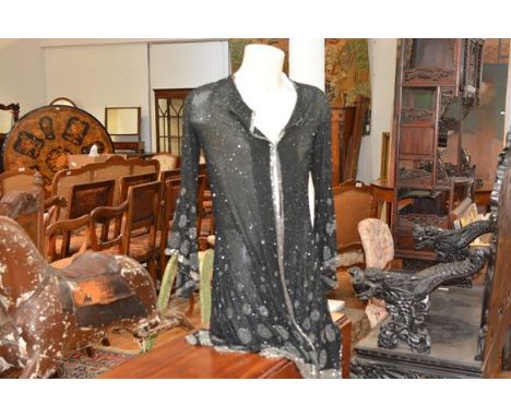 A vintage heavily beaded lady's evening jacket, decorated with clear and black bugle beads in circular patterns with flared s
