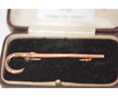 A 9ct gold brooch, modelled as a walking stick, of hollow construction, cased. Length 65mm