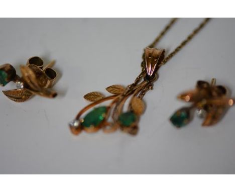 A suite of emerald and diamond set jewellery comprising a pendant and pair of earrings en suite comprising a leaf-form pendan