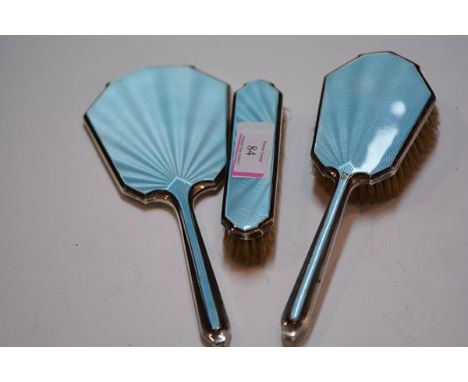 A George VI silver and sky blue engine turned enamel three piece dressing table set, Birmingham 1946.