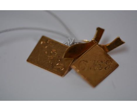A pair of Indian gold cufflinks, unmarked, each rectangular plate monogrammed and chainlinked to a dagger form backplate. 8.7