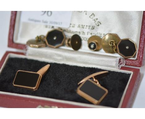 A pair of gentleman's 14ct gold and black onyx cufflinks, each rectangular plaque within a gold frame and with chain link to 