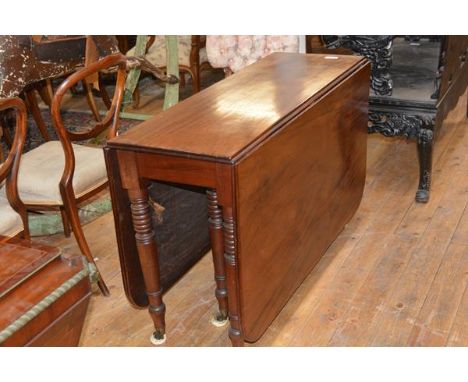 A William IV mahogany dropleaf dining table, the top with reeded edge and rounded corners, on ring-turned legs moving on cast