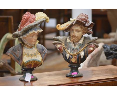 A pair of late 19th century Continental pottery busts, probably Austrian, of a lady and gentleman, each in feathered hat, she