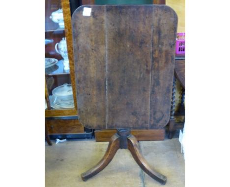 An Antique Oak Tilt-Top Table, the table having a rectangular top on turned column and tripod  base, approx 77 x 57 x 75 cms.