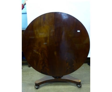 An Antique Circular Mahogany Tilt Top Dining Table, the table on column support with three feet on casters, approx 123 x 75.