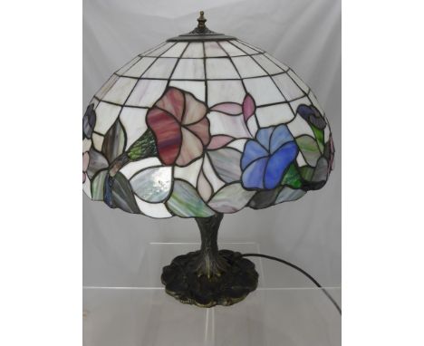 A Tiffany Style Lamp on Naturalistic Base, the shade depicting a Morning Glory design, approx 70 cms high.