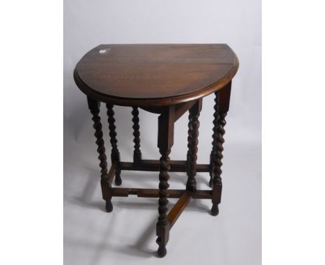 An Oak Drop Leaf Table on barley twist legs, approx 92 x 60 cms.