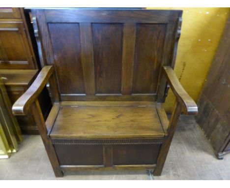 An Oak Monk's Table/Settle, having panelled back with lift up seat, approx 81 x 46 x 107 cms