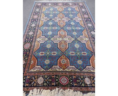 A Woollen Persian Style Rug, the rug having a light blue background with six central medallions, floral design and border, ap