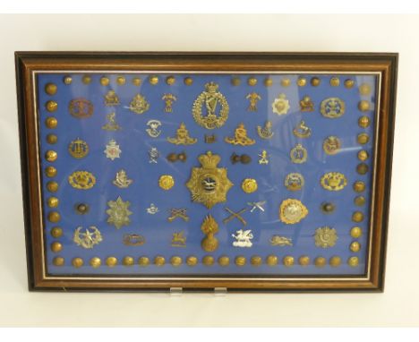 A Framed Display of Military Insignia, including Koyu helmet plate and other items.