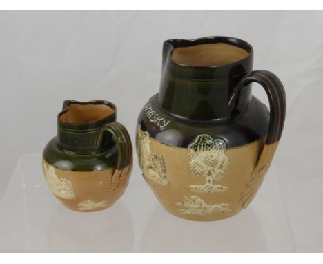 A Doulton Lambeth Ware Stone Ware Jug for Dewars Whisky, together with a Royal Doulton Stone Ware Jug for Gillons Old Scotch,