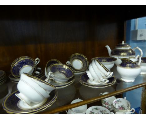 A Part Royal Worcester Model No. W9424, the blue floral gilded set comprising tea pot, 2 x sugar bowls (one WF), milk jug, ni