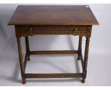 An Antique Oak Table, the table having carved front with turned legs on stretchers, approx 55 x 63 cms. .