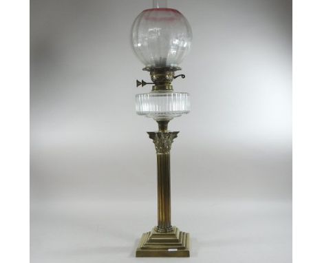A 19th century brass oil lamp, in the form of a Corinthian column, with an etched glass shade, 77cm high overall