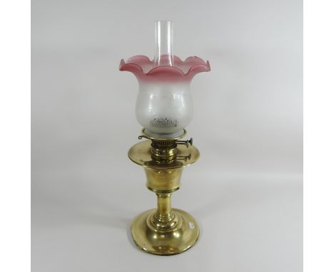 A cast iron and brass hanging oil lamp, with a white glass shade, 30cm