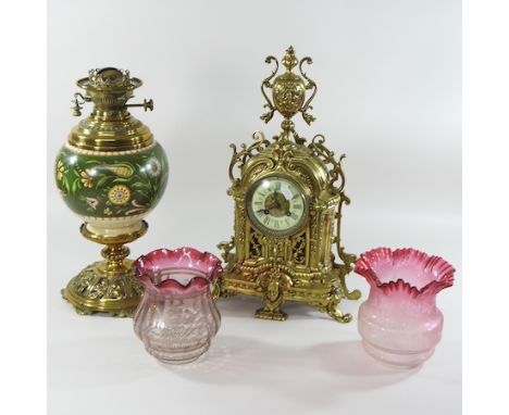 An ornate French brass cased mantel clock, 47cm high, together with a brass oil lamp