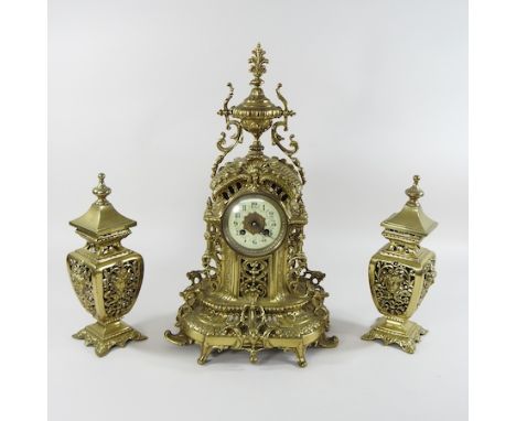 An ornate French brass cased mantel clock garniture, 50cm high