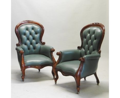 A pair of Victorian style green upholstered button back armchairs