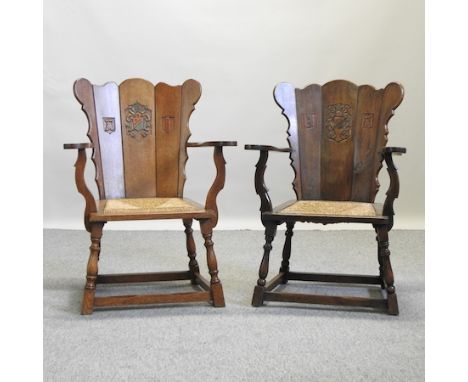 A pair of early 20th century carved light oak armchairs