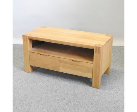 A light oak coffee table, containing drawers, 100cm