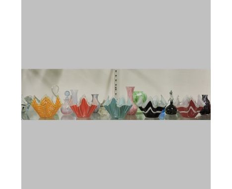 A shelf of coloured glass, to include handkerchief vases, tallest 15cm