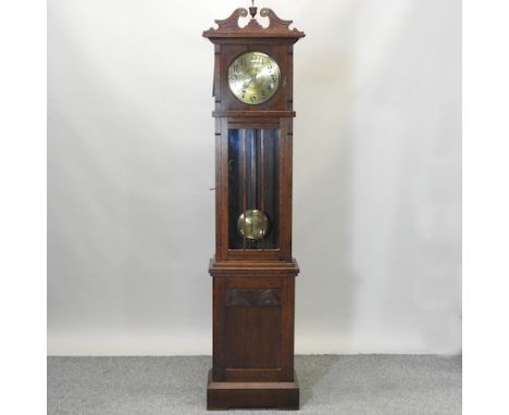 A 20th century oak cased longcase clock, the brass dial showing Arabic numerals, 210cm high